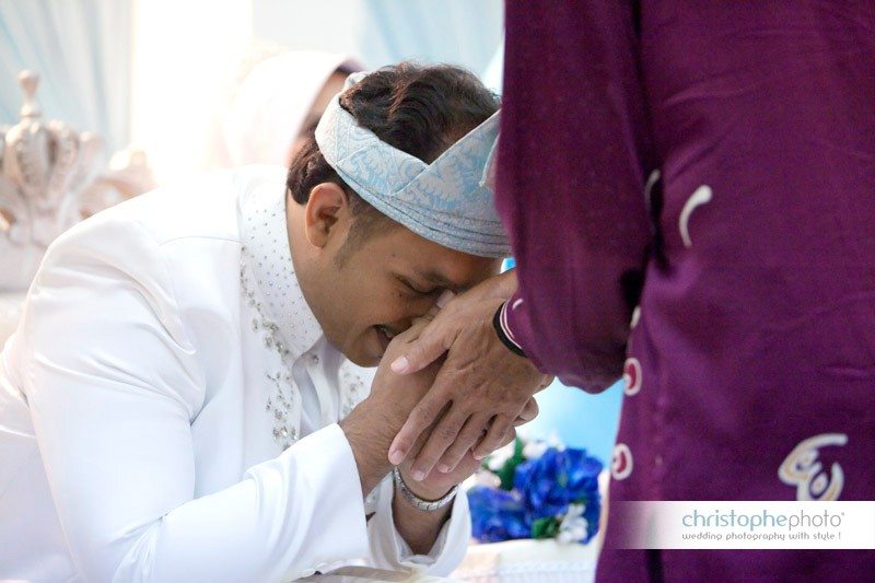 The groom is getting emotional. He takes the hands of the guest on his face as a sign of recognition. Captured by Wedding Photographer Malaysia