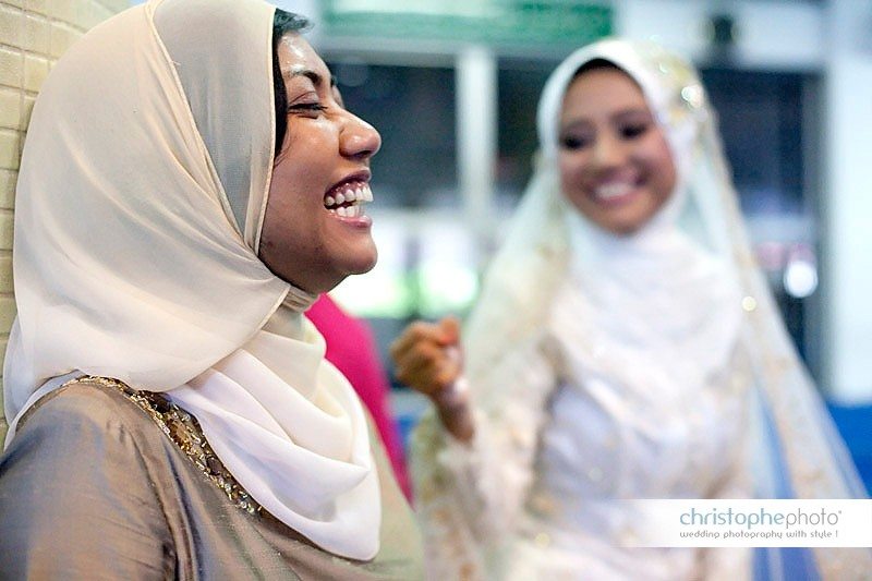 Sister of the bride having a good laugh at the Mosque in Ipoh Malaysia.