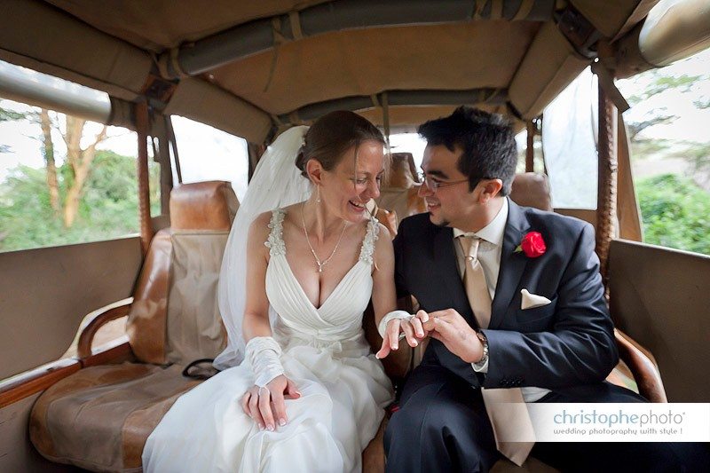 bride and groom having fun in the wedding car.