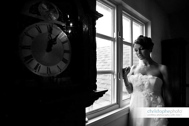The bride getting ready by the window of house as seen by Wedding Photographer Seattle