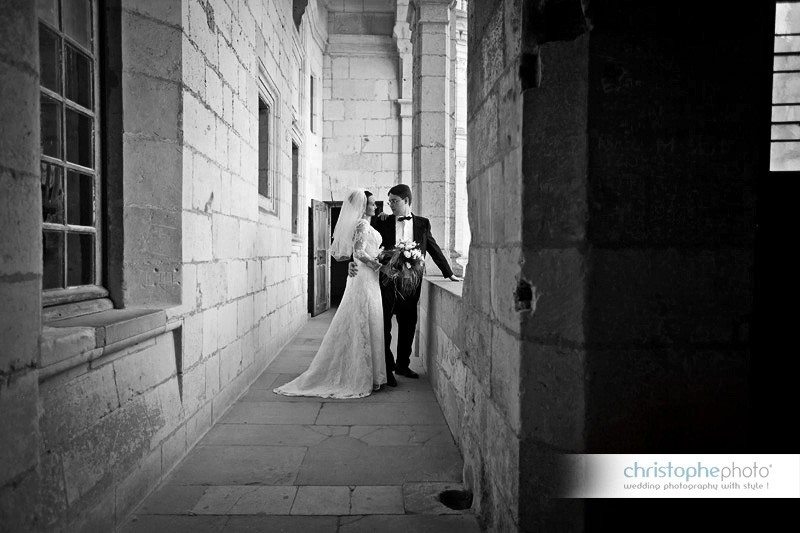 Black and white picture of the russian bride and groom exploring the little corners of the Chateau. 