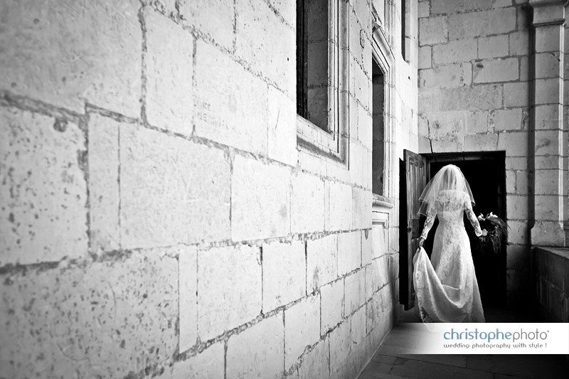 Black and white shot of the bride going trough the little door. 