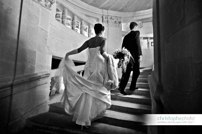 Bride and groom climbing the famous Double Helix Staircase designed by Leonardo da Vinci in Chateau de Chambord France. Image taken by wedding photographer france Christophe Viseux