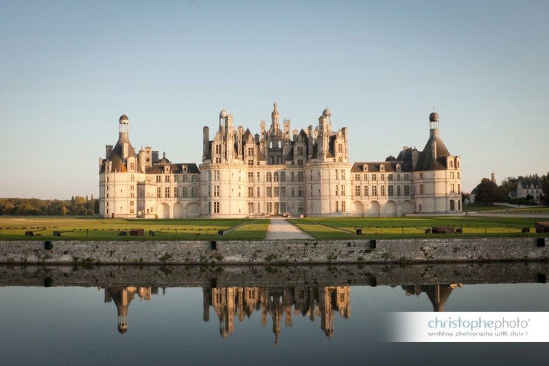 The Renaissance style Chateau de Chambord in the summer sunset light. Captured by wedding photographer france