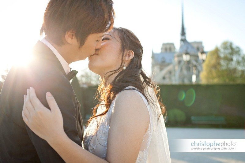Kissing in the late afternoon sun in Paris during a pre wedding portrait session