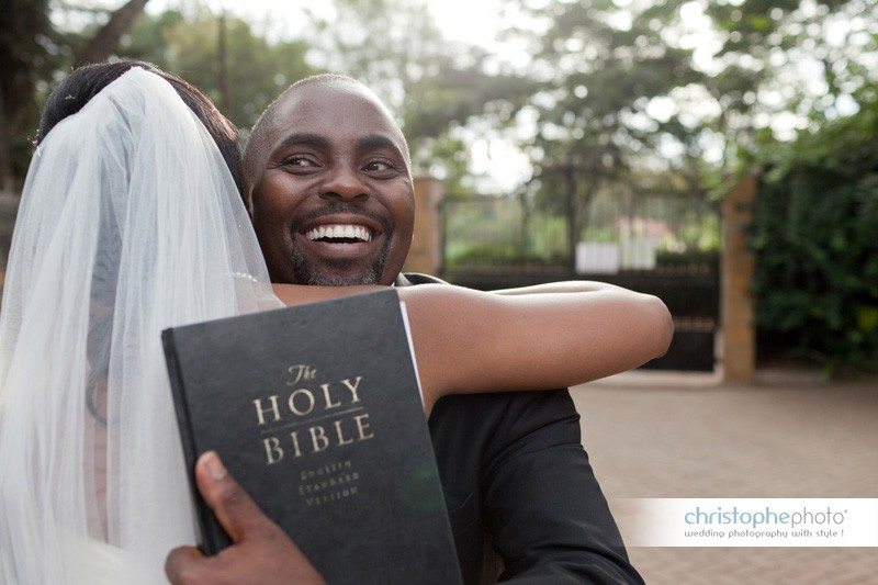 The priest holding the bride with the Holy Bible