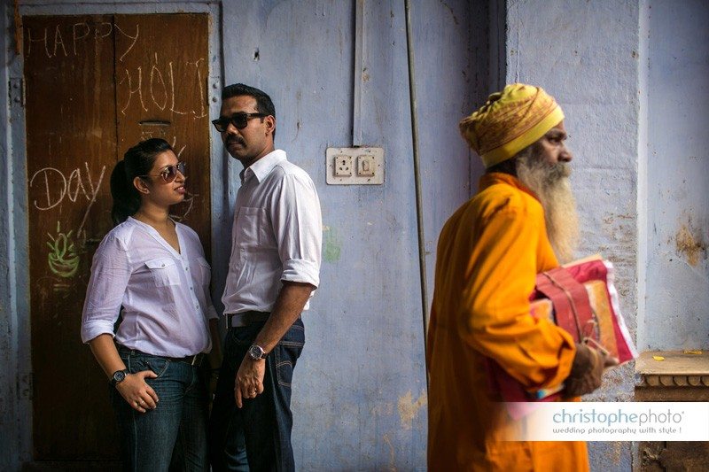 A classic portrait with a holy man passing by in Jaipur. Documentary photography India. 