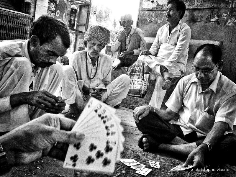 Groupe of men playing cards near Jaipur as documented by french photographer Christophe Viseux